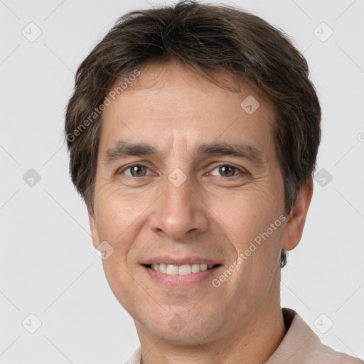 Joyful white adult male with short  brown hair and brown eyes