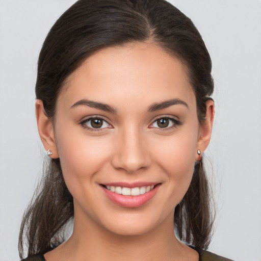 Joyful white young-adult female with long  brown hair and brown eyes