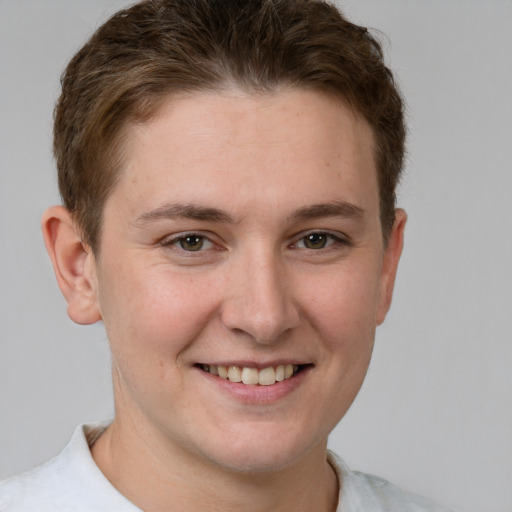 Joyful white young-adult female with short  brown hair and grey eyes