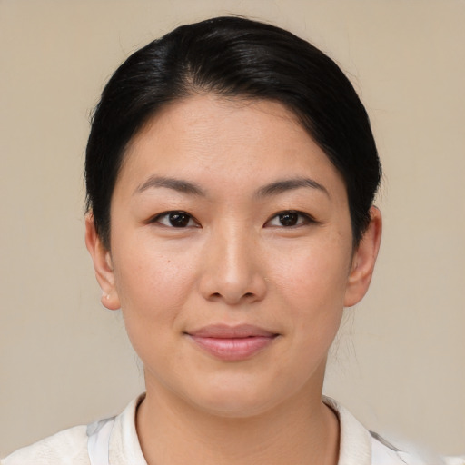 Joyful asian young-adult female with short  brown hair and brown eyes