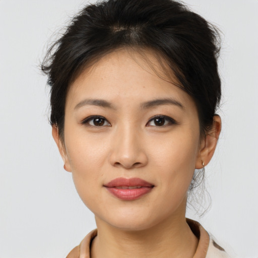 Joyful asian young-adult female with medium  brown hair and brown eyes