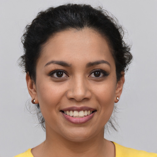 Joyful latino young-adult female with short  brown hair and brown eyes