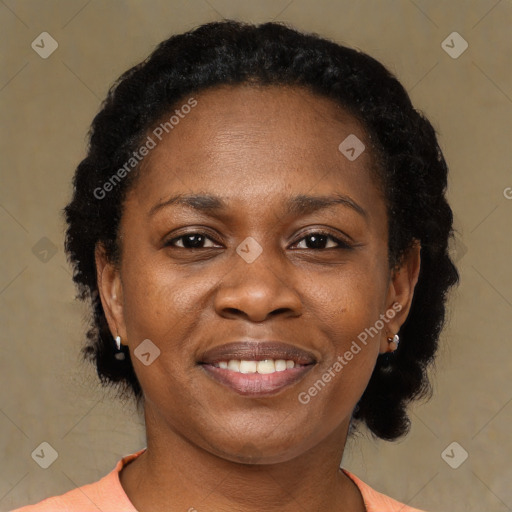 Joyful black adult female with short  brown hair and brown eyes