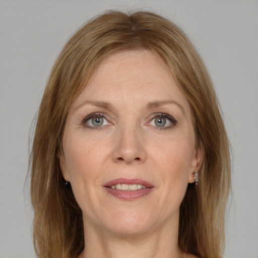 Joyful white adult female with medium  brown hair and grey eyes