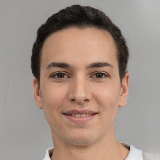 Joyful white young-adult male with short  brown hair and brown eyes