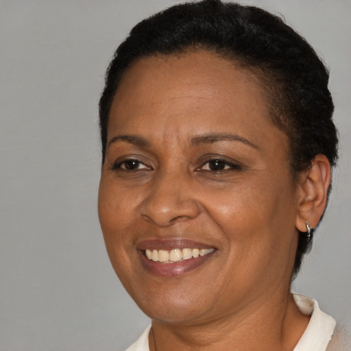 Joyful black adult female with short  brown hair and brown eyes