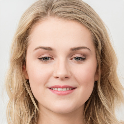 Joyful white young-adult female with long  brown hair and blue eyes