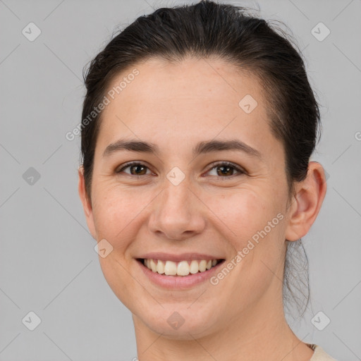 Joyful white young-adult female with short  brown hair and brown eyes