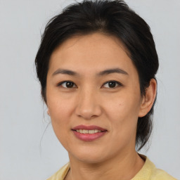 Joyful asian young-adult female with medium  brown hair and brown eyes