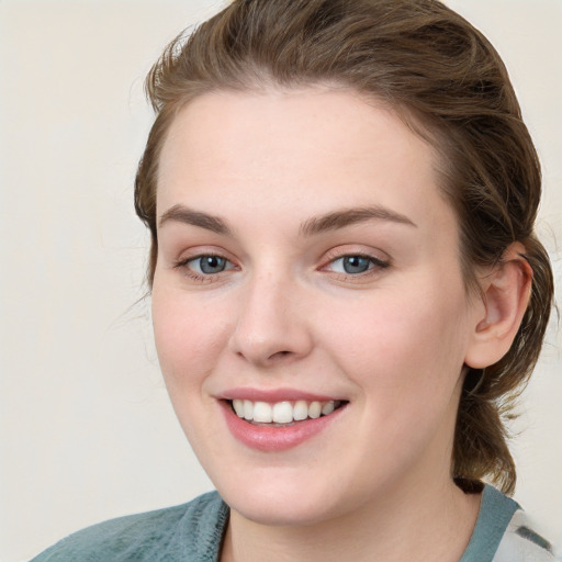 Joyful white young-adult female with medium  brown hair and blue eyes