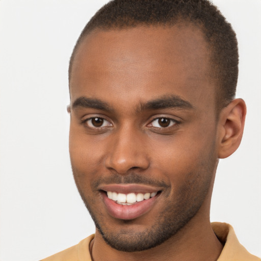 Joyful black young-adult male with short  brown hair and brown eyes