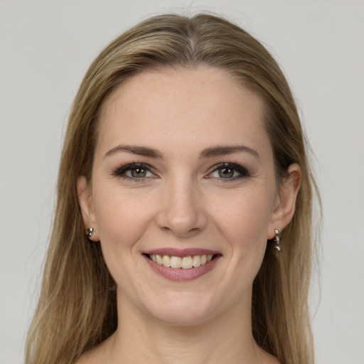 Joyful white young-adult female with long  brown hair and green eyes