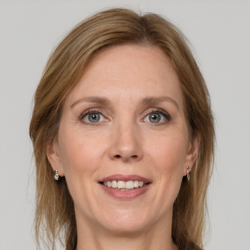 Joyful white adult female with medium  brown hair and grey eyes