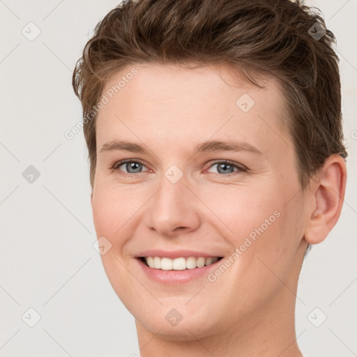 Joyful white young-adult female with short  brown hair and grey eyes