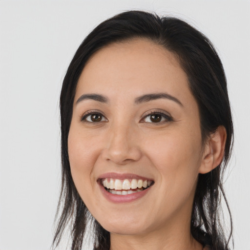 Joyful white young-adult female with long  black hair and brown eyes