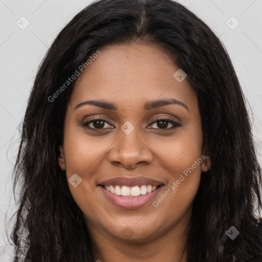 Joyful black young-adult female with long  brown hair and brown eyes