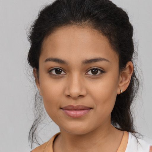 Joyful latino young-adult female with medium  brown hair and brown eyes