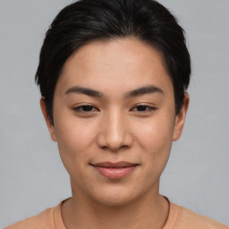 Joyful asian young-adult female with short  brown hair and brown eyes