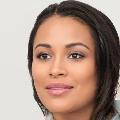 Joyful latino young-adult female with long  black hair and brown eyes