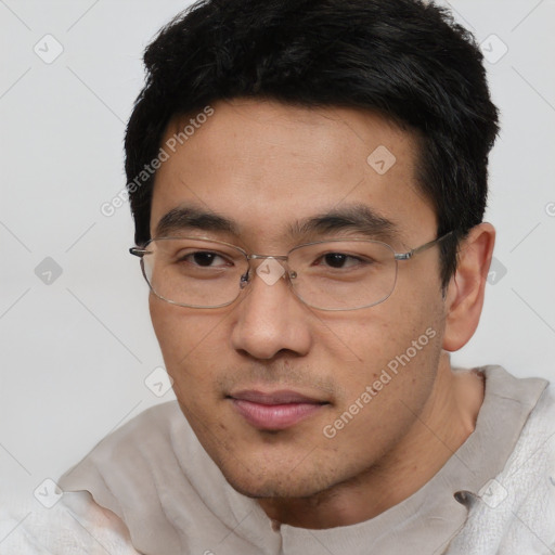 Joyful asian young-adult male with short  black hair and brown eyes