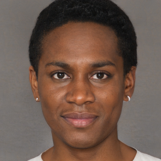 Joyful black young-adult male with short  black hair and brown eyes