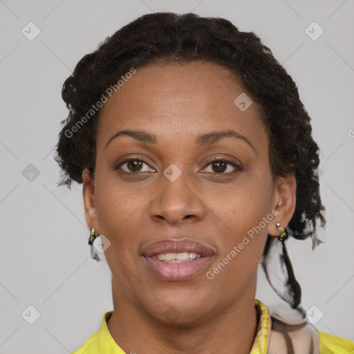 Joyful black adult female with short  brown hair and brown eyes