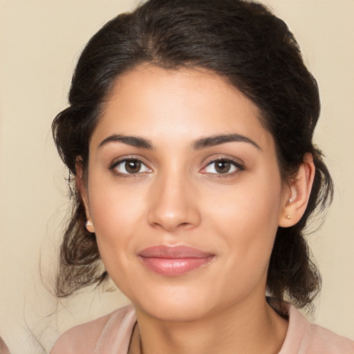 Joyful latino young-adult female with medium  brown hair and brown eyes