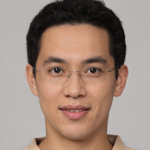 Joyful latino young-adult male with short  brown hair and brown eyes