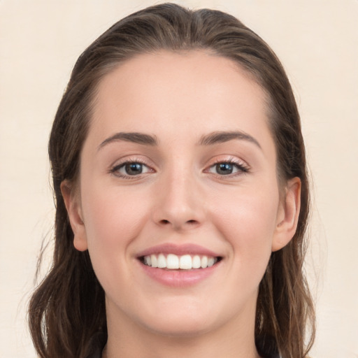 Joyful white young-adult female with long  brown hair and grey eyes