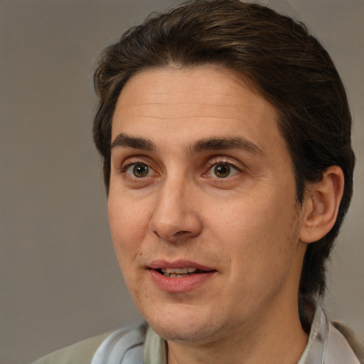 Joyful white adult male with medium  brown hair and brown eyes