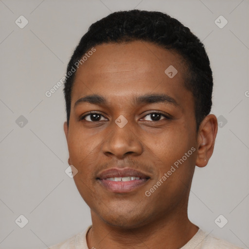 Joyful black young-adult male with short  black hair and brown eyes