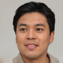 Joyful asian young-adult male with short  brown hair and brown eyes