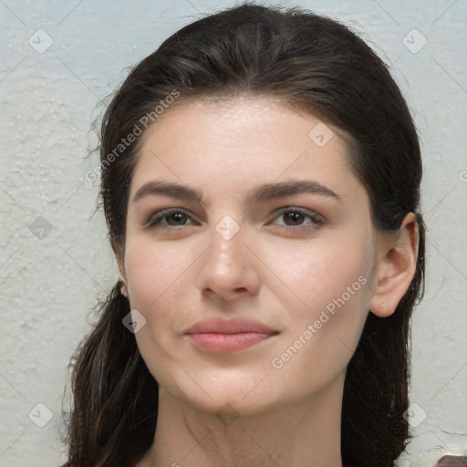 Joyful white young-adult female with long  brown hair and brown eyes