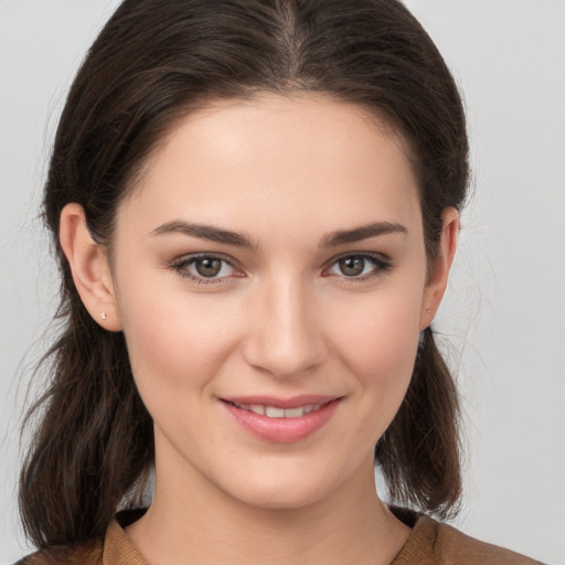 Joyful white young-adult female with medium  brown hair and brown eyes