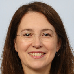 Joyful white adult female with long  brown hair and brown eyes