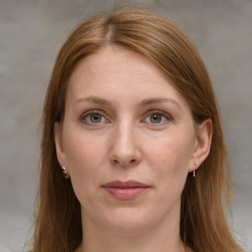 Joyful white adult female with long  brown hair and grey eyes