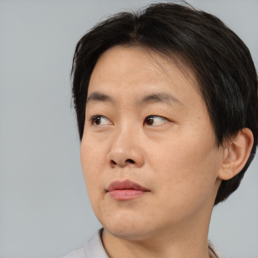 Neutral asian young-adult male with short  brown hair and brown eyes