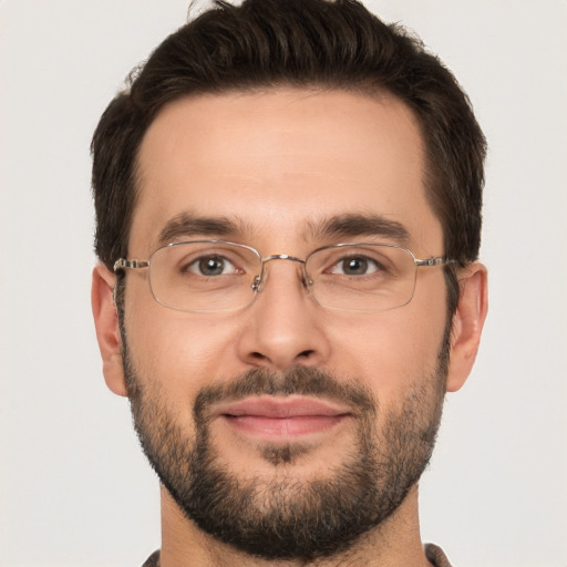 Joyful white adult male with short  brown hair and brown eyes