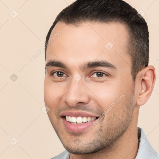 Joyful white young-adult male with short  brown hair and brown eyes