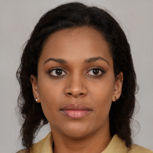 Neutral black young-adult female with medium  brown hair and brown eyes
