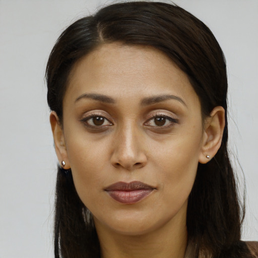 Joyful black young-adult female with long  brown hair and brown eyes