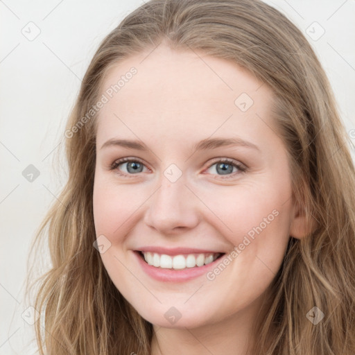 Joyful white young-adult female with long  brown hair and blue eyes