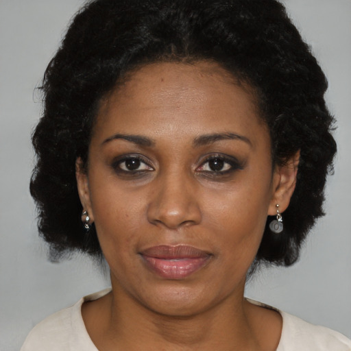 Joyful black adult female with short  brown hair and brown eyes