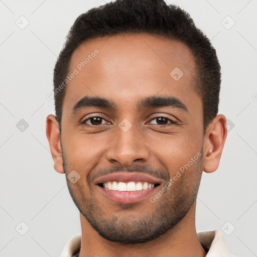 Joyful latino young-adult male with short  brown hair and brown eyes