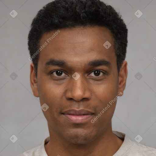 Joyful black young-adult male with short  black hair and brown eyes