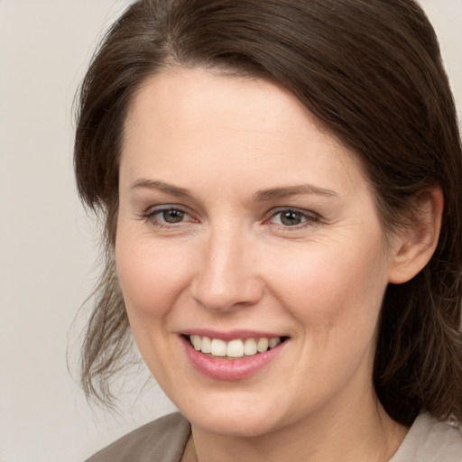 Joyful white young-adult female with medium  brown hair and brown eyes