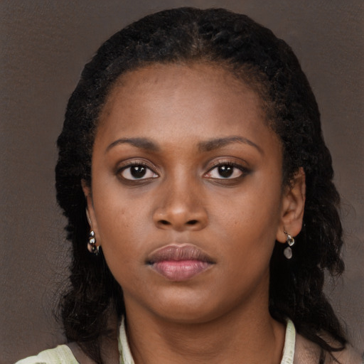 Neutral black young-adult female with long  brown hair and brown eyes