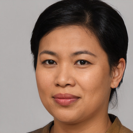 Joyful asian young-adult female with medium  brown hair and brown eyes