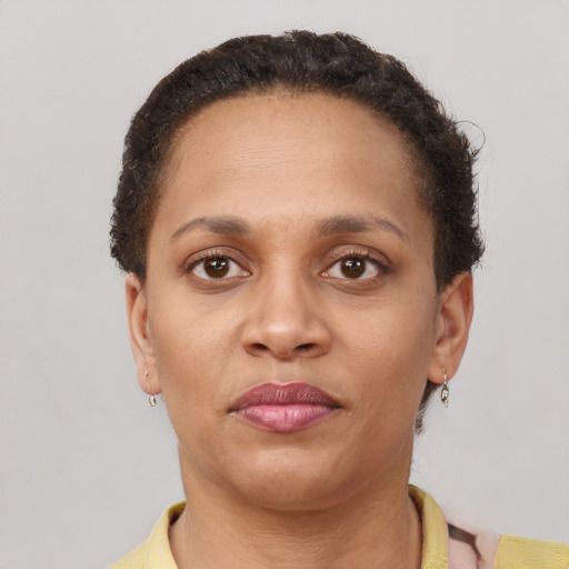 Neutral latino adult female with short  brown hair and brown eyes
