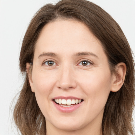 Joyful white young-adult female with long  brown hair and grey eyes